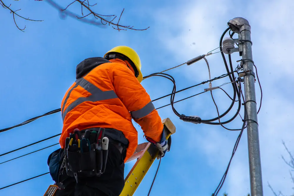 A,Telecoms,Operative,Is,Seen,Working,From,A,Ladder,On